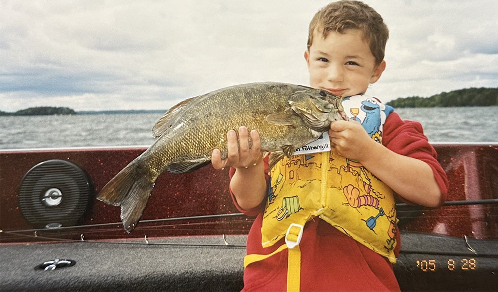 A young Easton Fothergill prepares to release a nice smallmouth bass