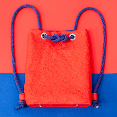 Red and blue backpack made of vegan pineapple fibre and recycled climbing rope