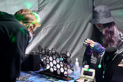 customer at Silver Age Jewelry booth at Electric Pow Wow festival in Utah in 2022