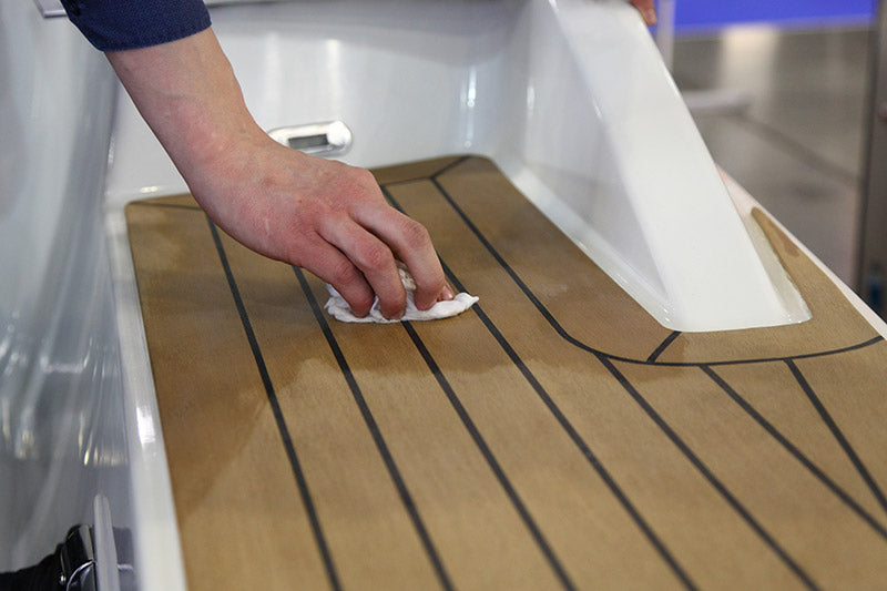 A person cleaning boat flooring