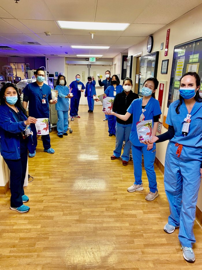 Hospital workers holding SuperBeets products donated from HumanN