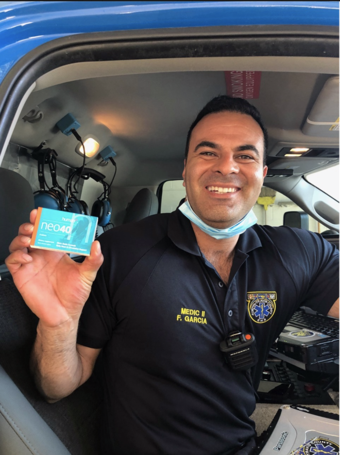 EMT worker holding donated Neo40 products from HumanN