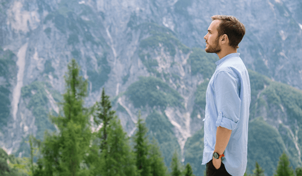 Man practicing meditation on a mountainside