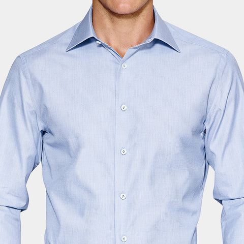 Example of no front placket shirt. Image shows a man wearing a light blue shirt