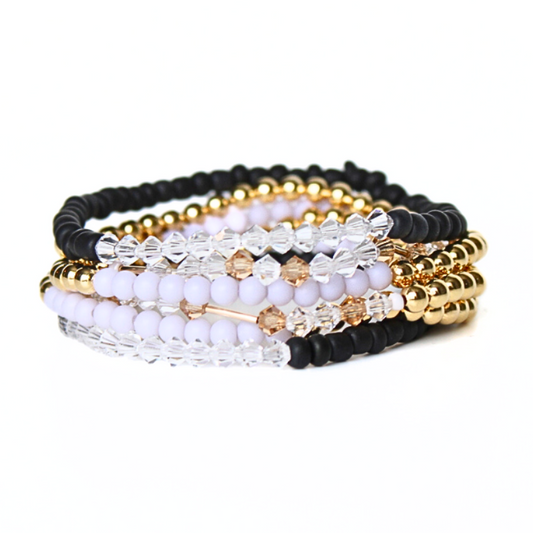 Black polymer stretch bracelet with gold cylinder bead