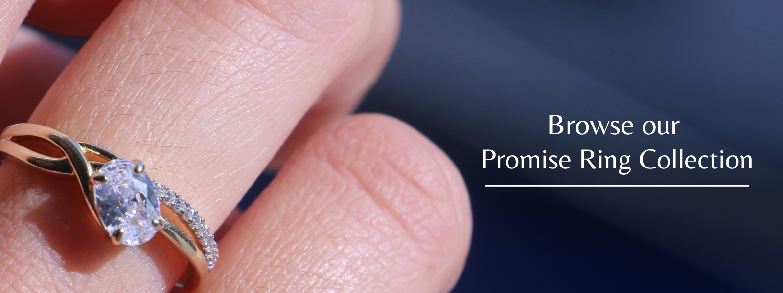 Photo of close up of gold promise ring on finger with the text browse our promise ring collection