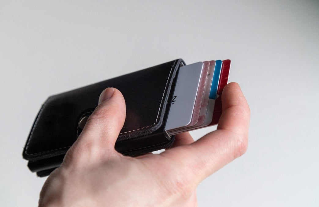 hand holding wallet with credit cards