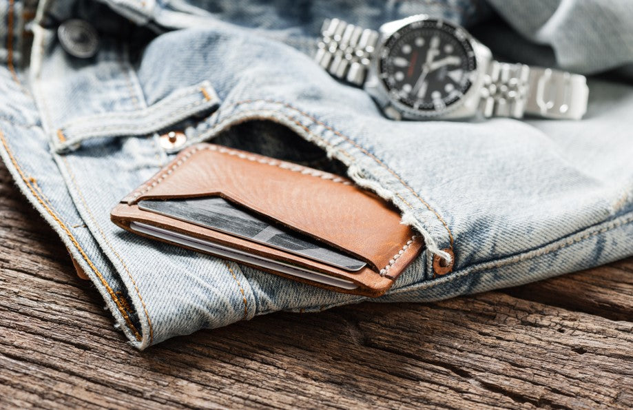 jeans with wallet in front pocket and watch on it