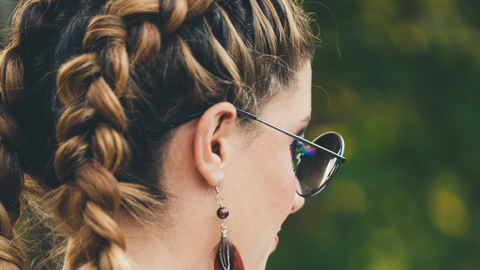 Avoid loose ends with styles like french braids; woman wearing french braid in brown 2c/3b hair