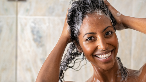 Woman with 2c/3b waves and curls washing hair