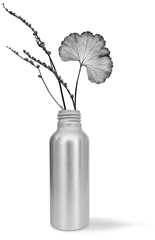 an image of an empty skinder london radiance smartmist bottle being reused and a flower vase