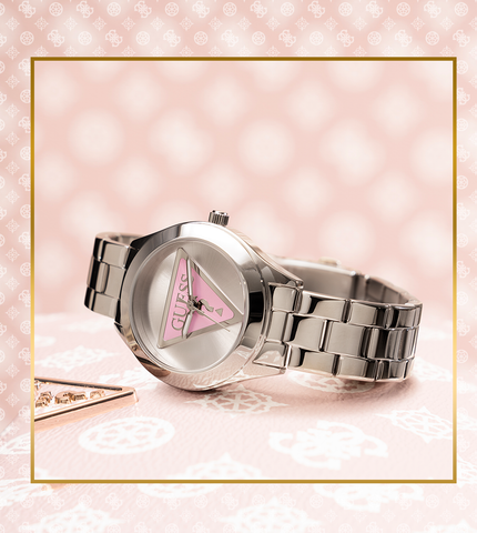 GUESSWatches logo silver watch with pink triangle logo on patterned background