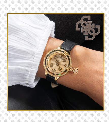 GUESSWatches gold logo watch with patterned dial and black strap on patterned background