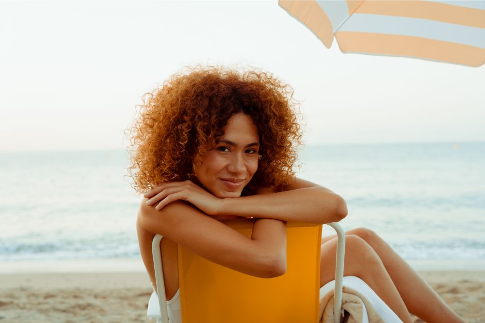 woman relaxing at beach with great skin