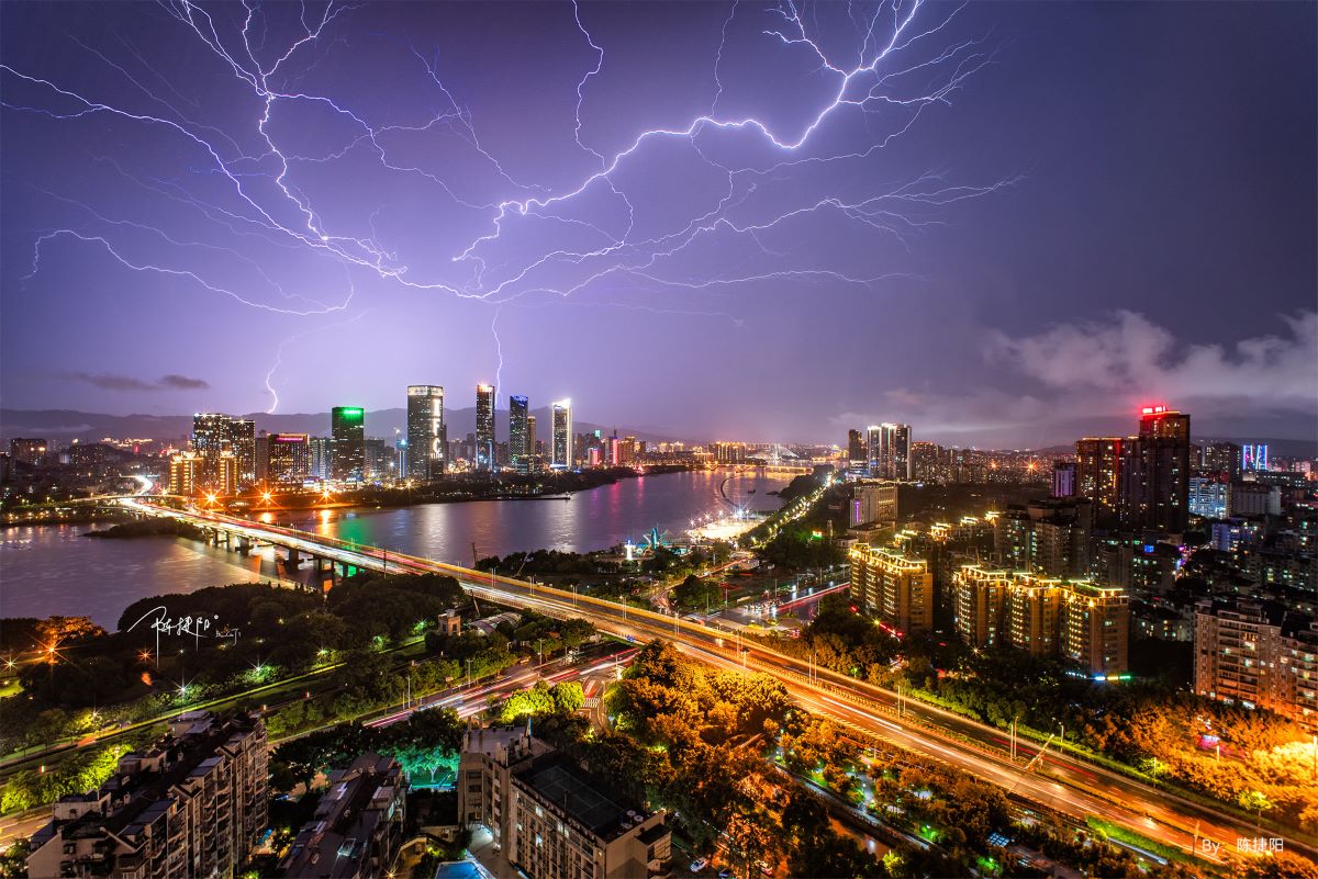 Night cityscape with lightning in the sky captured using the TTARTISAN 10MM F2 APS-C lens