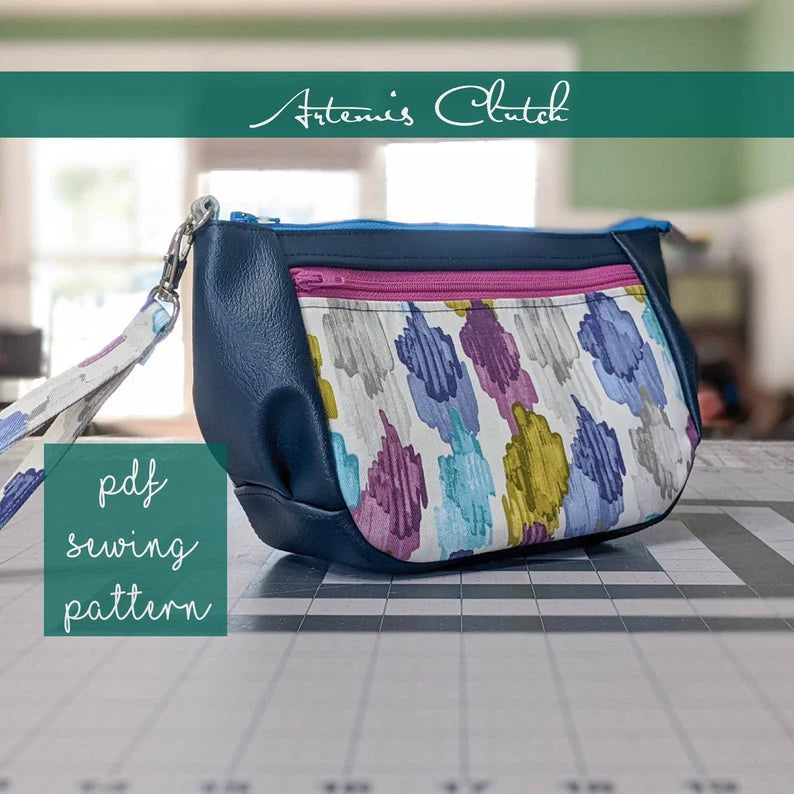 Colorful clutch bag with floral pattern and blue sides, labeled 'Artemis Clutch - PDF sewing pattern.'