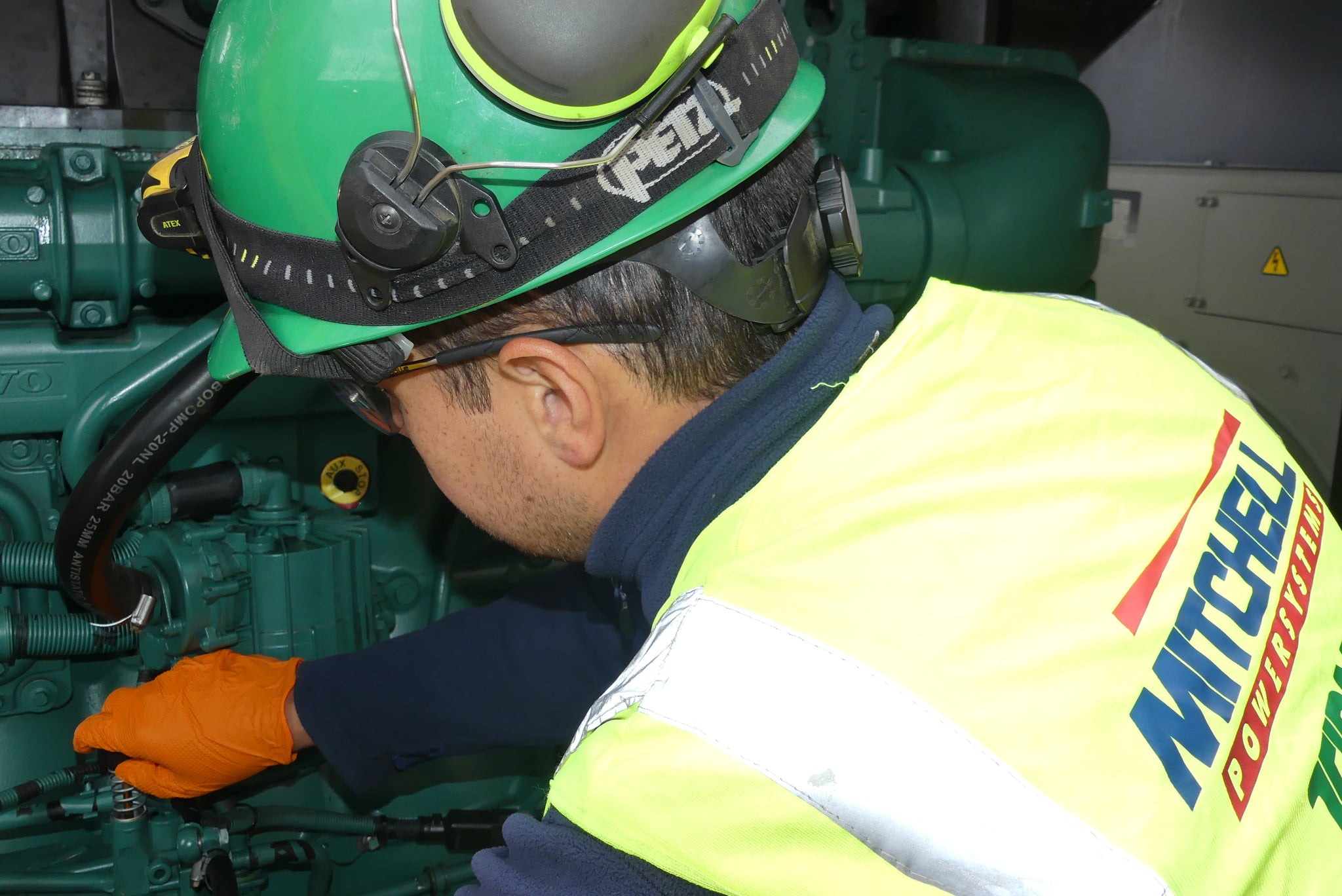 Mitchell's employee working on a diesel engine