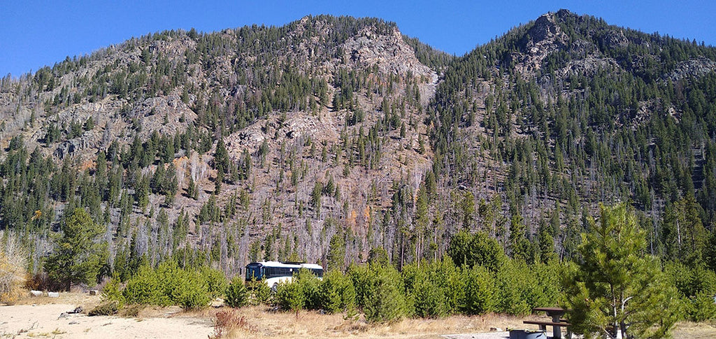 An RV parked in the mountains