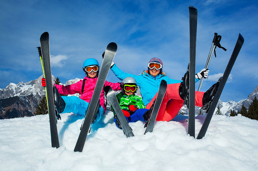 A family of skiers posing on the slopes.