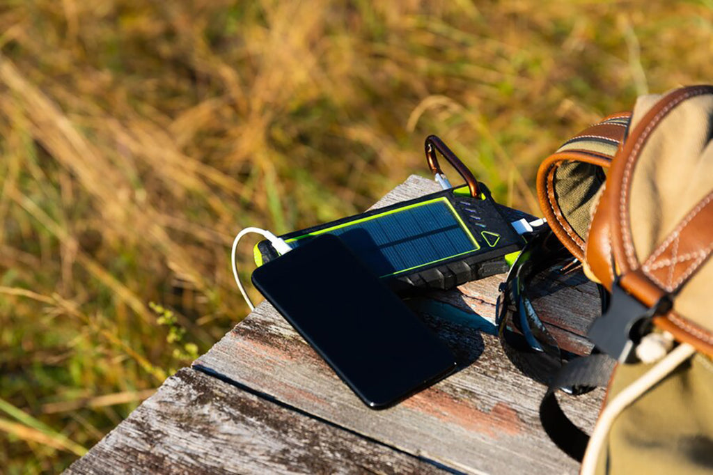 A solar power charger connected to a smartphone