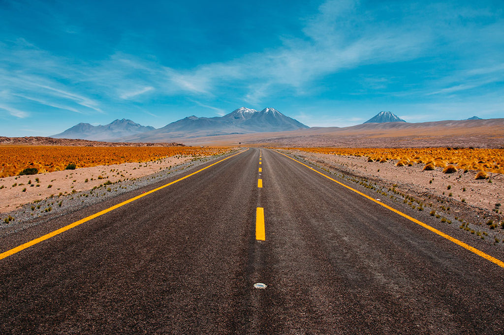 A road in a deserted area leading toward the mountains