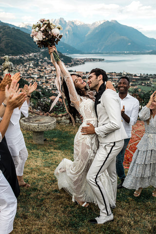 Villa Evalina in Lake Como, Italy bride cheering after ceremony with a lush bouquet