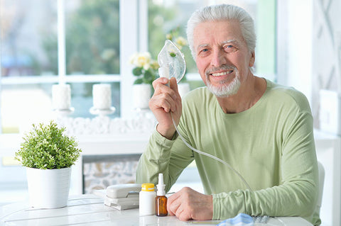 Man holding up nebulizer happily