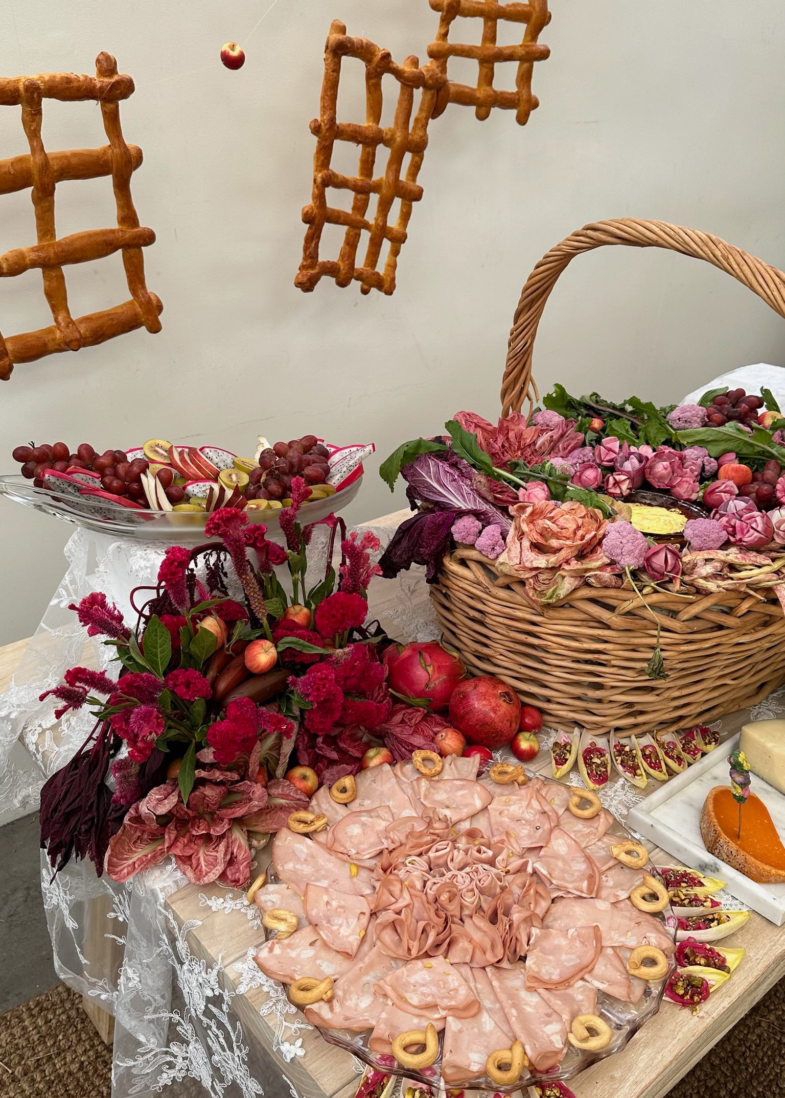 Emi Jay x Frankies Bikinis Event food trays and basket of flowers on table