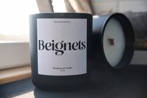 Beignets - a New Orleans candle by Parish Scents in a black vessel with a white label