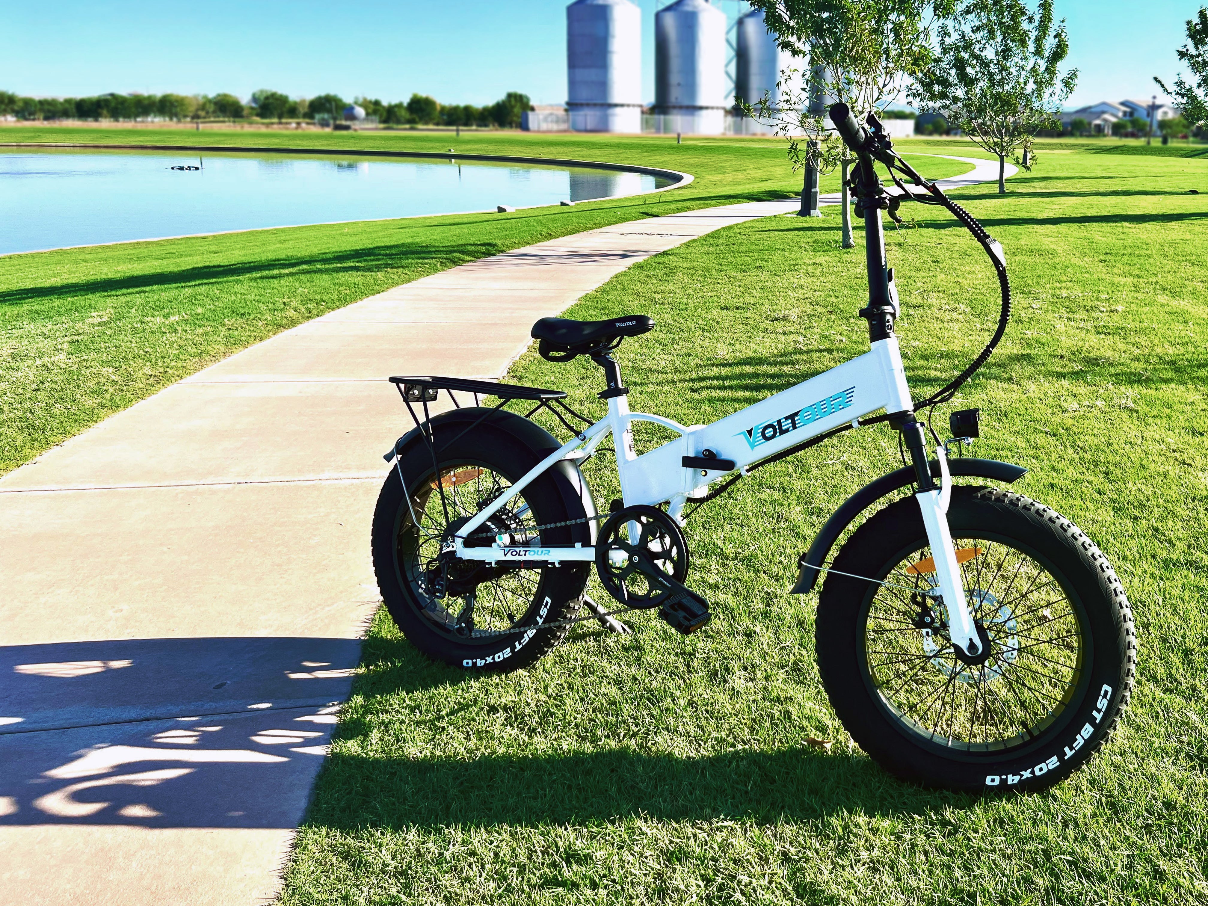 white-electric-bike-on-grass-with-lake-in-background