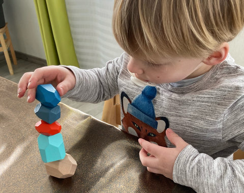 Development of fine motor skills with the wooden educational game Petit Menhir