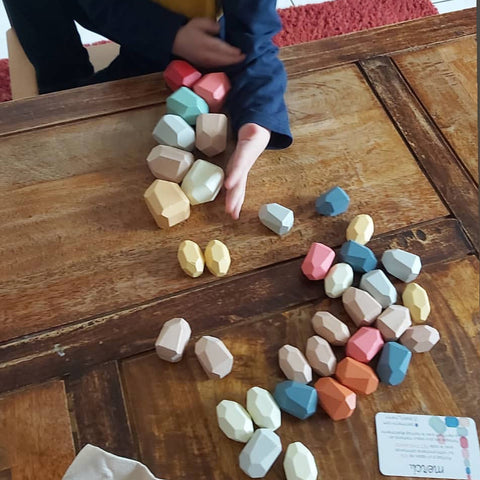 Wooden stones of the Montessori educational game Petit Menhir
