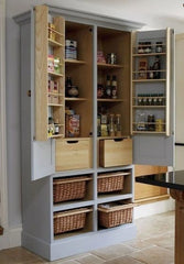 Repurposed armoire as a pantry painted grey with basket inserts