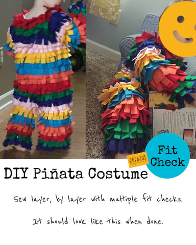 DIY piñata costume for toddler. Fit check photo of toddler boy wearing the bodysuit part of the piñata costume with rainbow colored fringe sewn on in layers.
