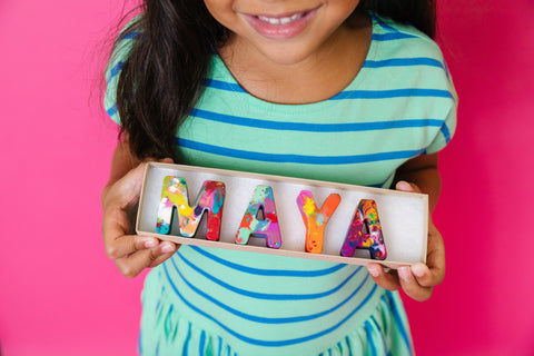 This kids rainbow crayon gift is an Easter gift idea for Kindergarten.  Pictured is an Easter present for kids as Name Crayons that spell MAYA