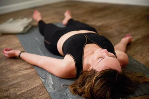 woman laying down in yoga pose