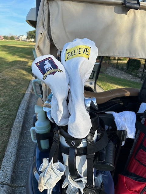 Ted Lasso Headcovers on back of golf cart on Believe & One Richmond Team Logo