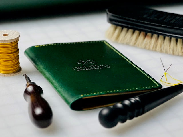 Green scorecard holder with leather working tools