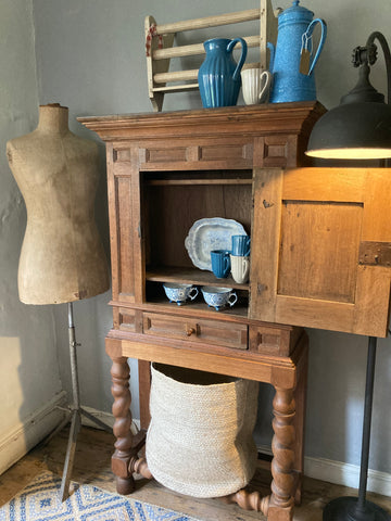 Antique wooden cupboard on legs at Source for the Goose