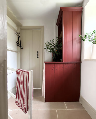 Dark red dresser in neutral toned hallway