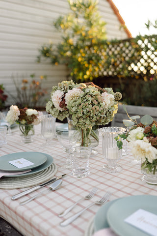 Table set outside with green ceramic dishes.