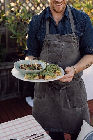 chef holding a platter with appetizers