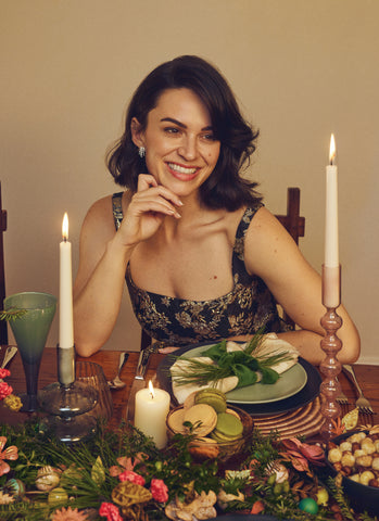 woman sitting at a table set for the holidays
