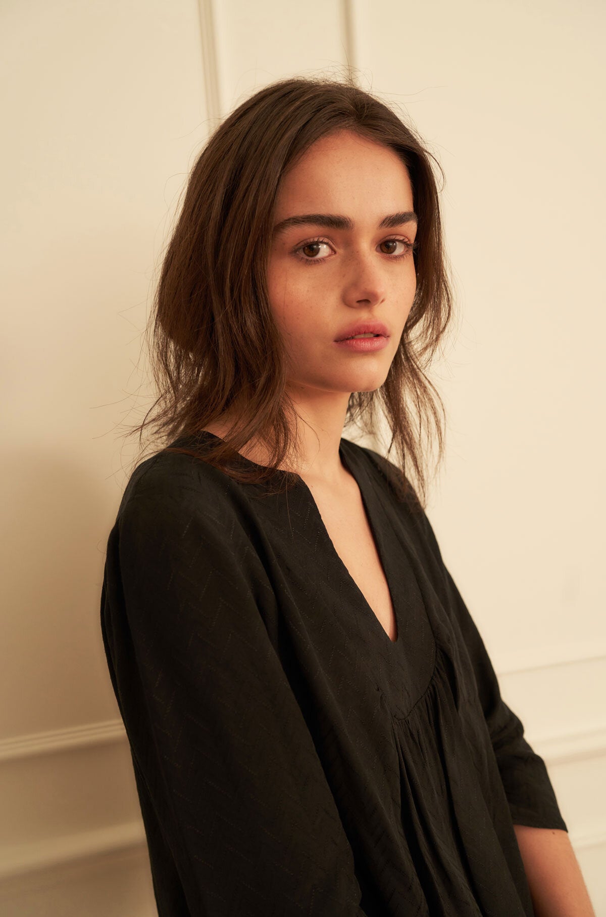 Girl wearing a black viscose top with 3/4 sleeves