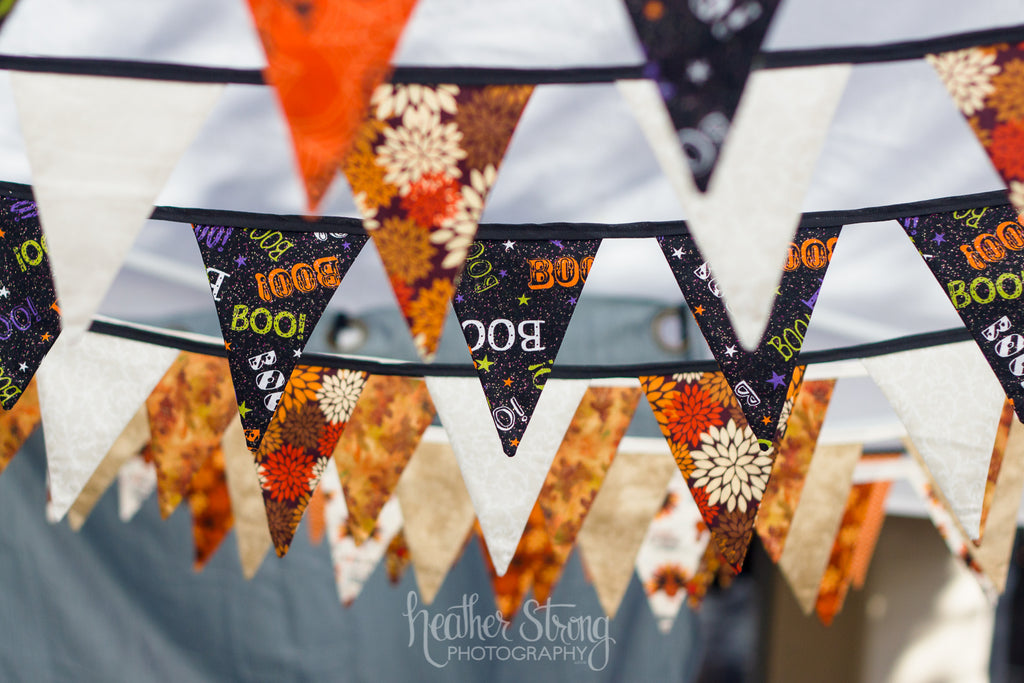 Bunting strings hanging from easy-up at craft fair