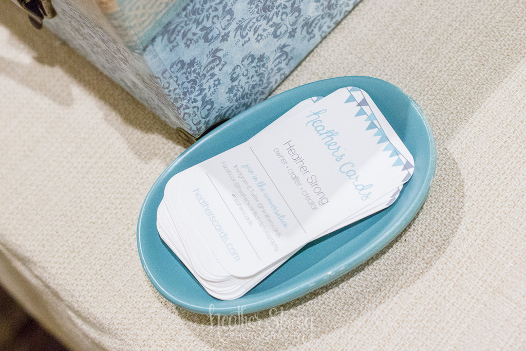 Vertically printed business cards in a blue dish