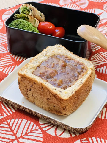 Japanese curry in pitted loaf of bread