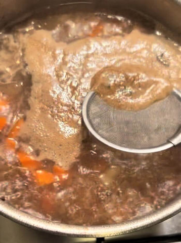 grey foam scum on top of boiling water for japanese curry recipe