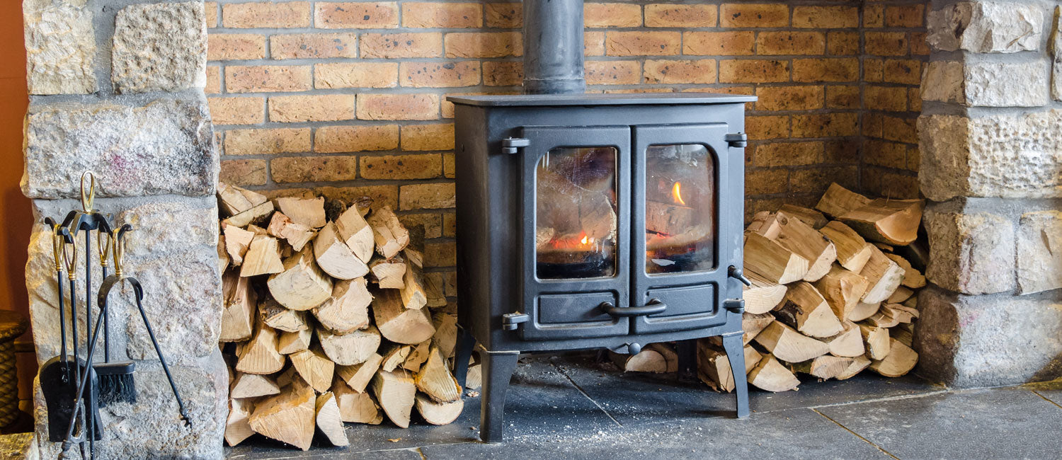 Fireplace with wood stacked next to it