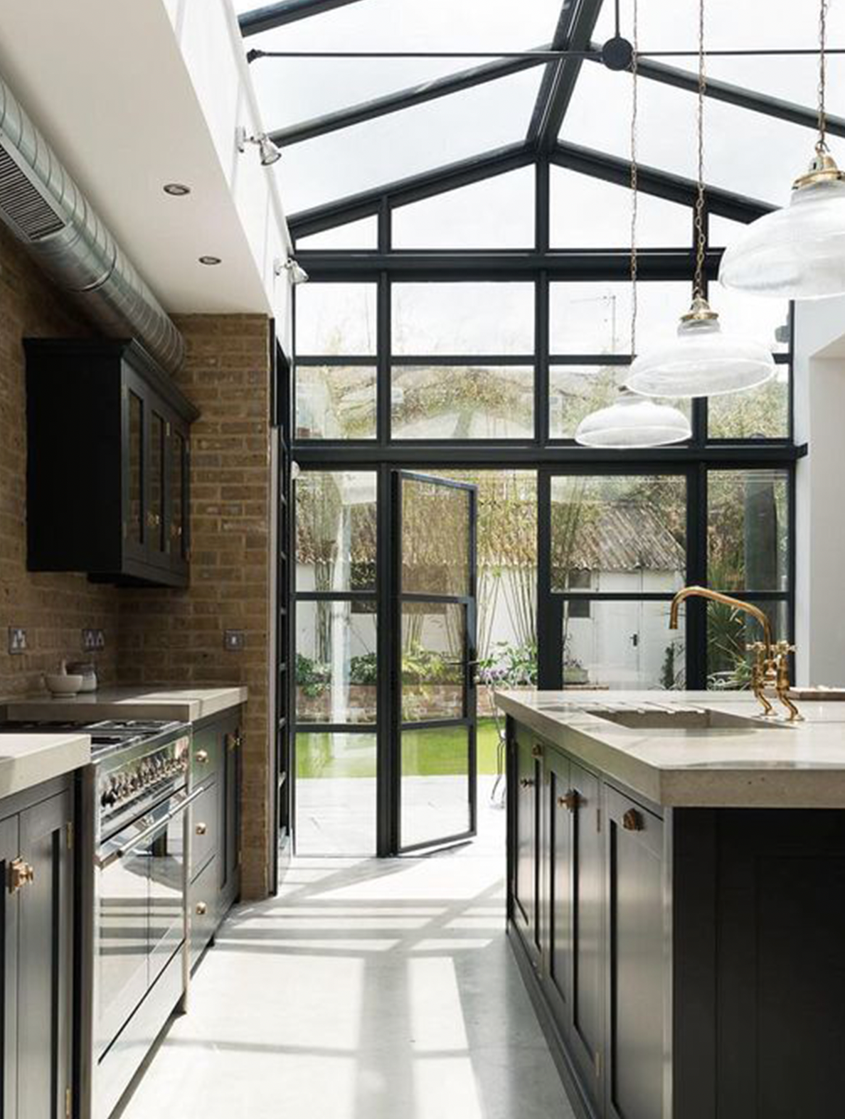 Beautiful kitchen with black framed windows and skylight.